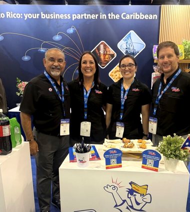 Four Pan Pepín team members at their branded counter in the Puerto Rico pavilion.